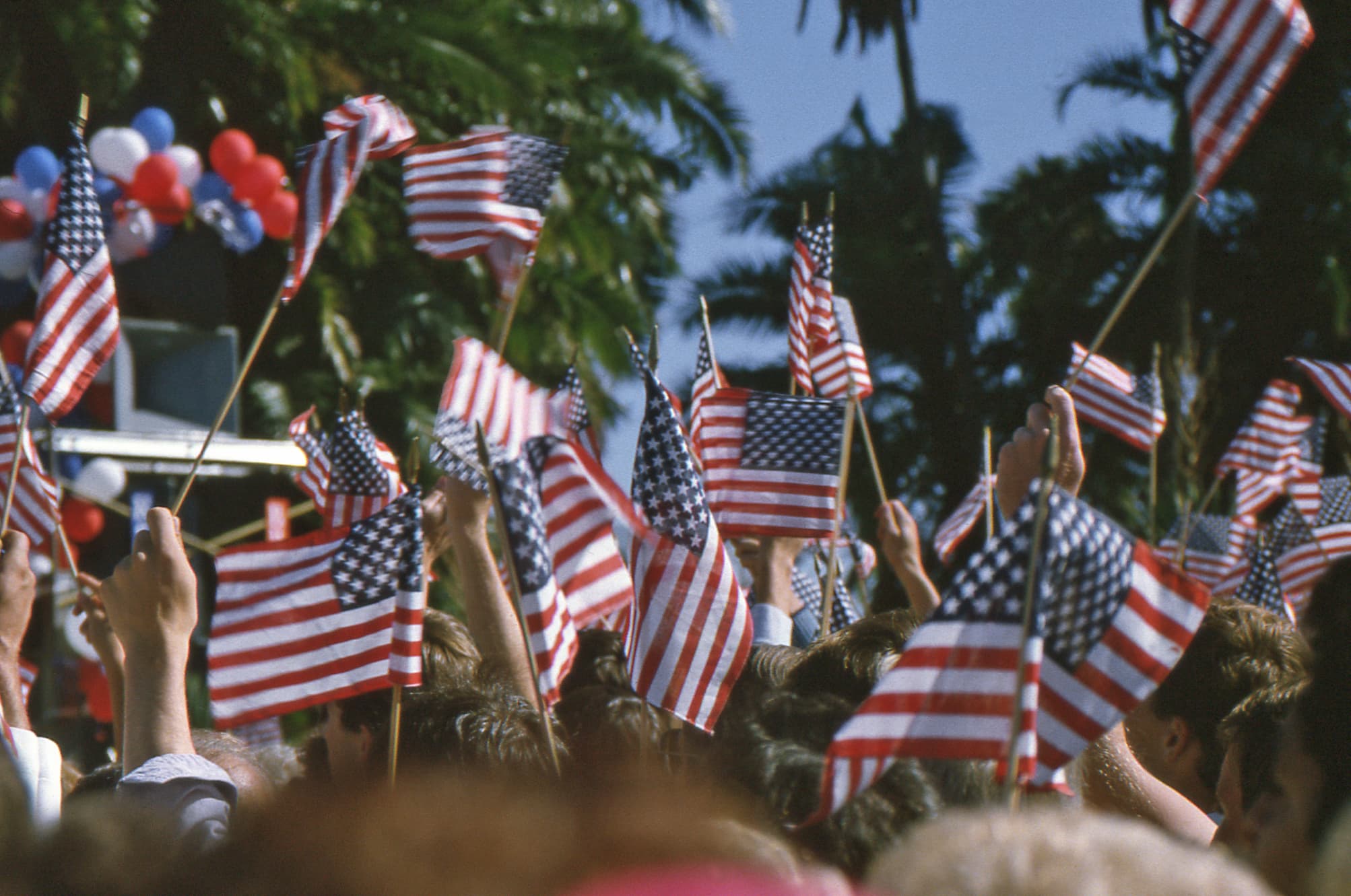 Crowd waving American flags